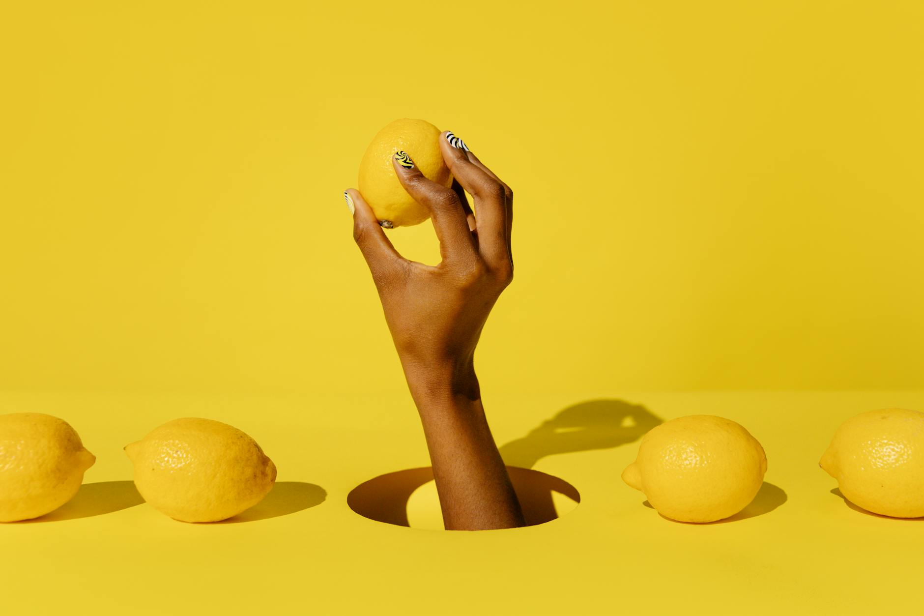 Colorful clitoral vibrators arranged on a bright yellow surface