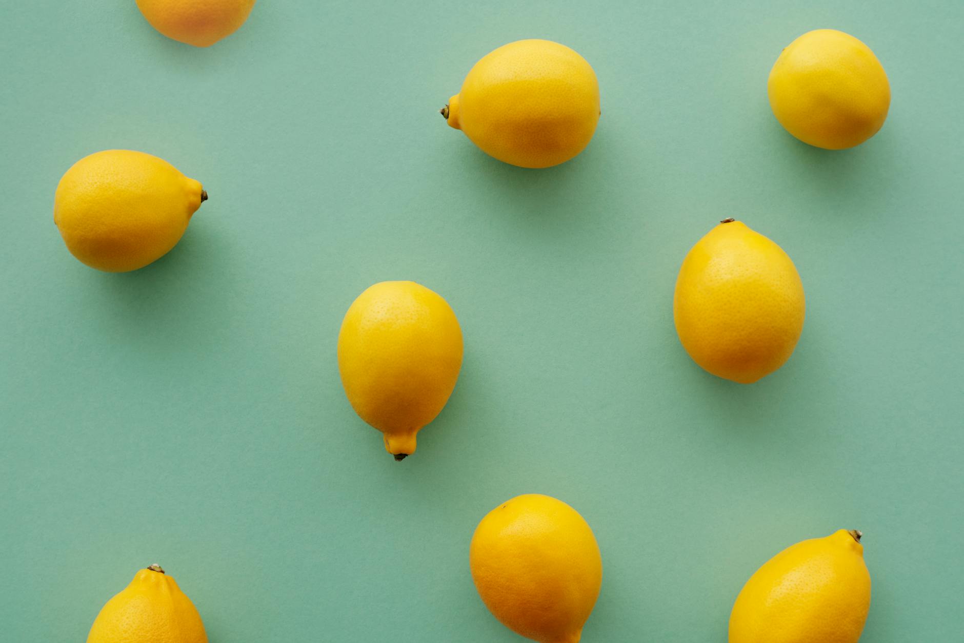 Bright yellow lemons arranged on a soft pastel background, representing recovery and renewal