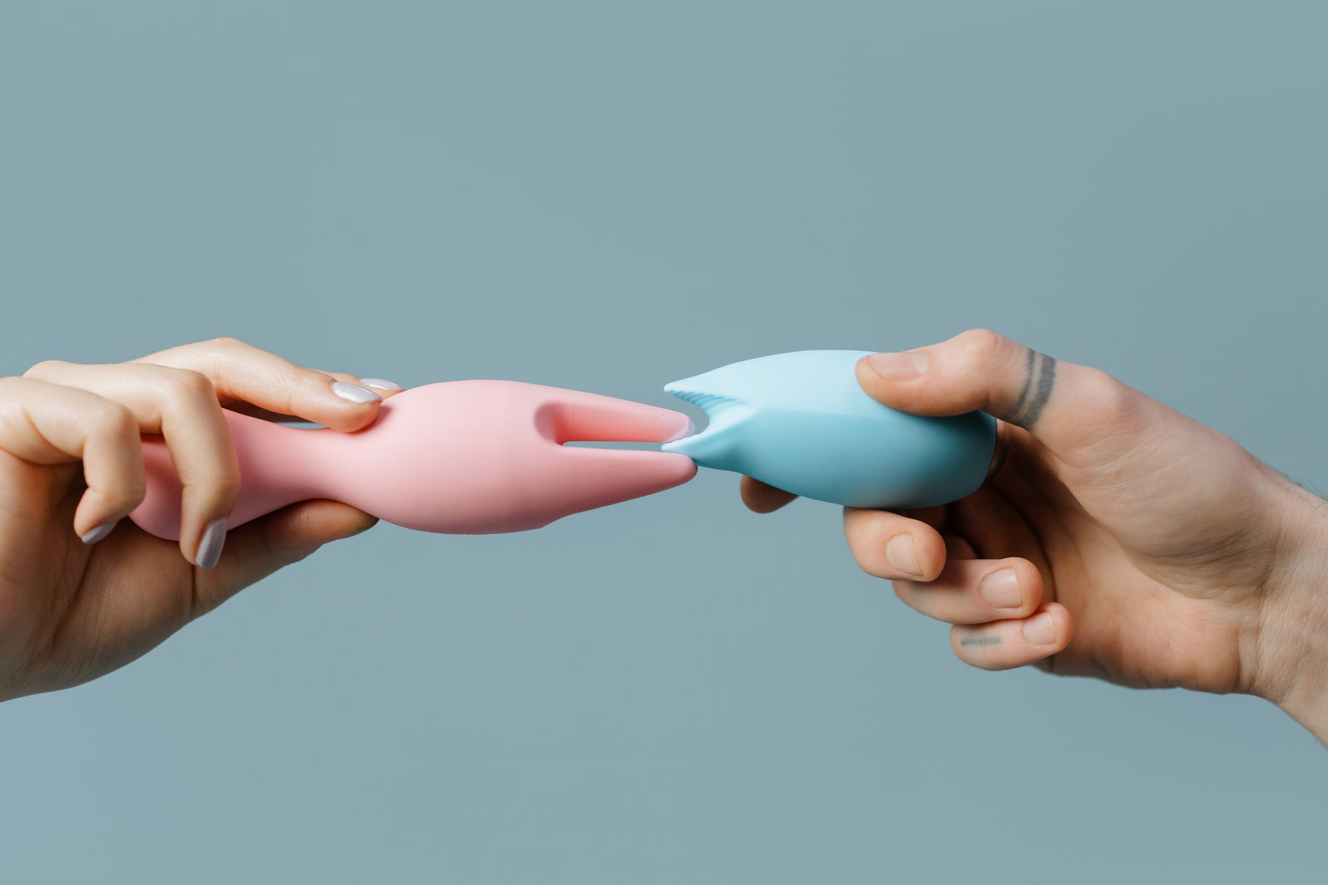 Hand holding fresh lemon on soft pink background symbolizing sensitivity restoration
